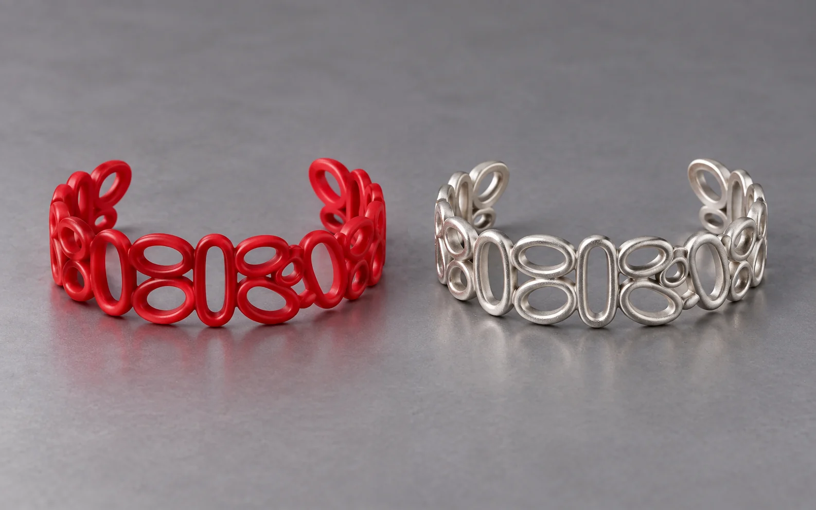 AI-generated illustration: Matching red wax cuff bracelet and silver-colored metal casting